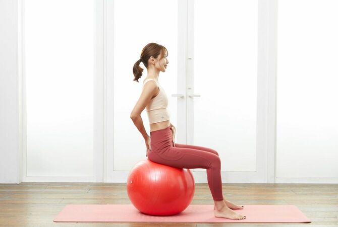 ［姿勢のポイント②］骨盤の角度が重要です。骨盤を立てて、ボールにまっすぐ突き刺すイメージで座りましょう