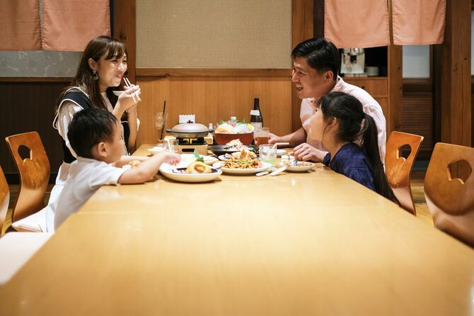 日本料理店で夕食を食べる家族