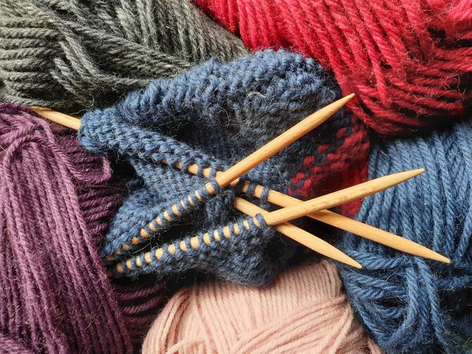 様々な色の毛糸と編み棒