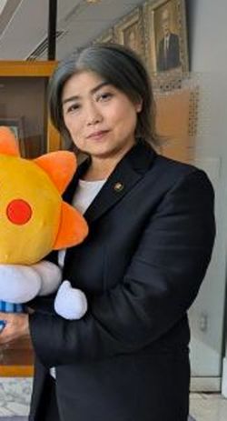 2025年7月、気象庁マスコットキャラクター「はれるん」に手を添える田久保眞紀市長